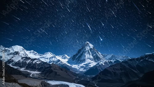 Snow capped mountains under a starry night sky landscape scene