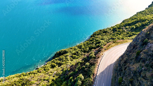 Photos Aerial View of Winding Mountain Road Beside Turquoise Lake Wakatipu