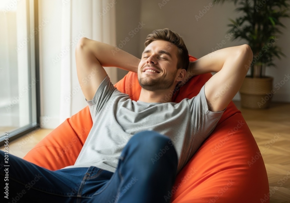 Fototapeta premium Man enjoying relaxation with arms stretched wide on a couch