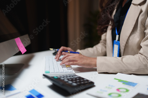 Employee working late researching business data at desk