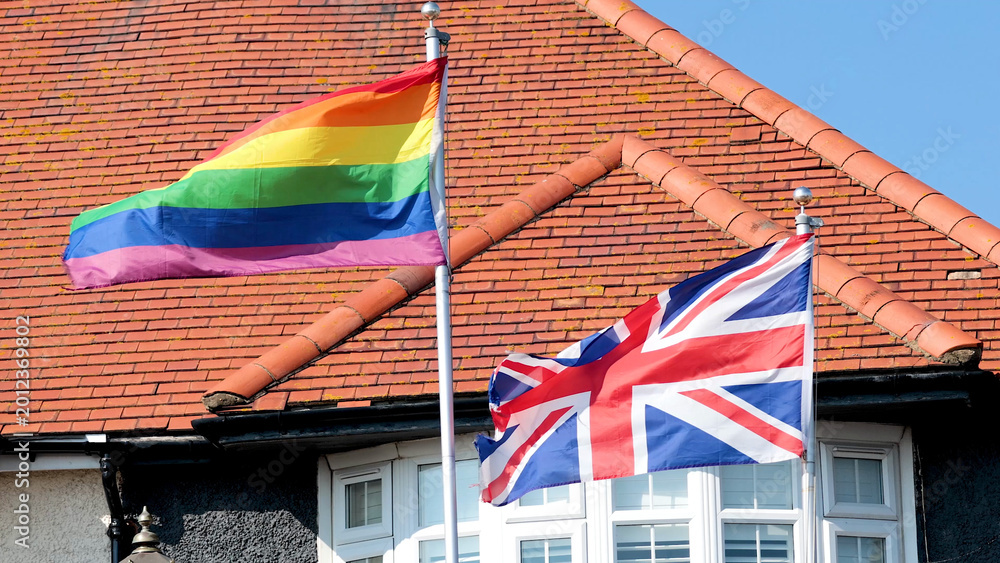 Naklejka premium Rainbow Pride Flag and Union Jack Flying Together in Brighton England