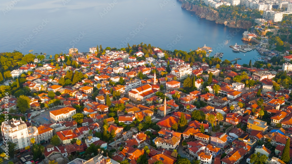 Fototapeta premium Antalya, Turkey. Aerial drone view featuring Kaleici Old Town, yacht marina, Mediterranean Sea and dramatic rocky coastline in morning light.. Aerial View