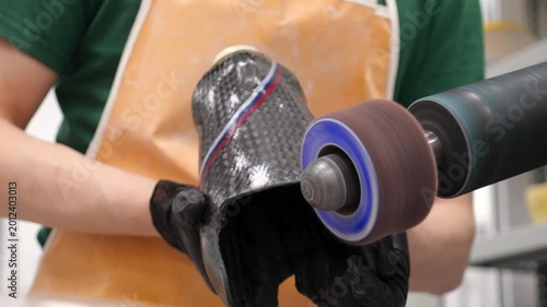 Technician sanding carbon fiber prosthetic leg socket