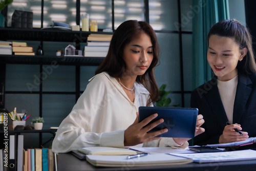 Asian boss businesswoman working with intern together in office room