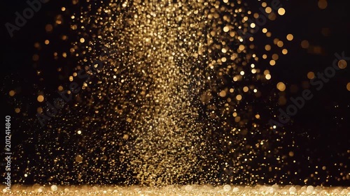 Golden Glitter Particles Exploding and Falling in Slow Motion.
