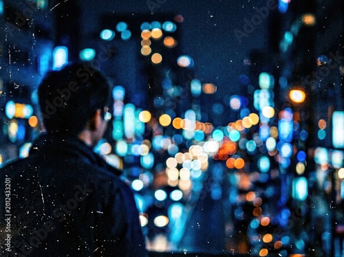 A solitary figure gazes out at a vibrant cityscape at night, bathed in the glow of countless lights, creating a sense of urban contemplation.