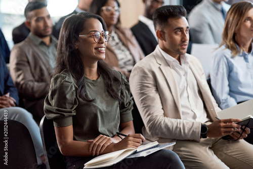 Fotografie Businesswoman, laugh and audience in seminar for presentation, notes and wealth management training