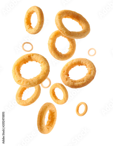 Delicious, golden-brown onion rings falling gracefully through the air