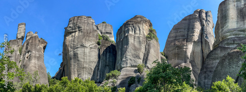 famous Meteora Greece, large view on sandstone pillars on blue sky background