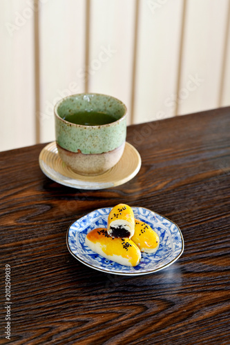 Chinese pastry and Japanese Matcha hot tea on wooden table