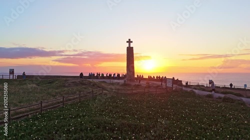 Cabo da Roca Cross at Sunset and Silhouettes of Tourists. Portugal. Aerial View. Orbiting