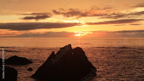 Sunset over the East China Sea with rocky coast in Amami Oshima, Japan