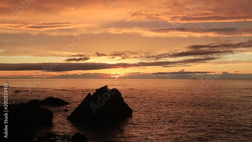 Sunset over the East China Sea with rocky coast in Amami Oshima, Japan
