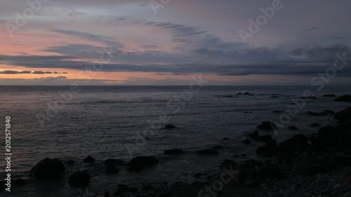 Sunset over the East China Sea with rocky coast in Amami Oshima, Japan