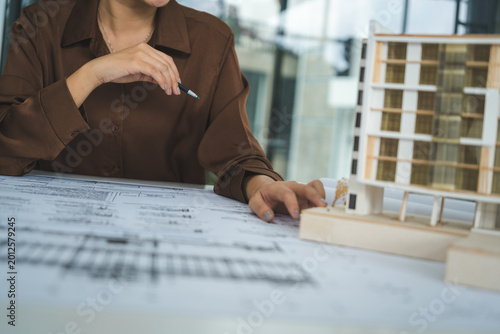 Female Architect Analyzing Modern Building Model