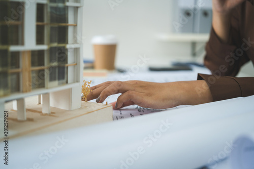 Female Architect Analyzing Modern Building Model