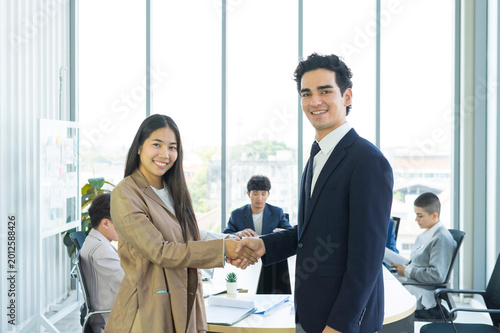Young business people are shaking hands after a business deal. Successful negotiations or interview.