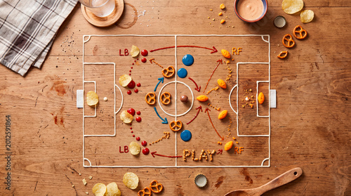 Creative arrangement of snack foods mimicking soccer game