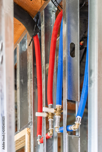 фотографія New pex plumbing pipes installed in metal stud wall