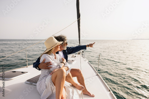 Senior couple sailing enjoying ocean view on yacht vacation