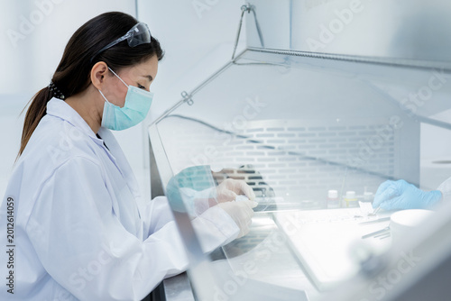 Researcher conducts experiments in a laboratory focused on scientific analysis and experimentation during daytime