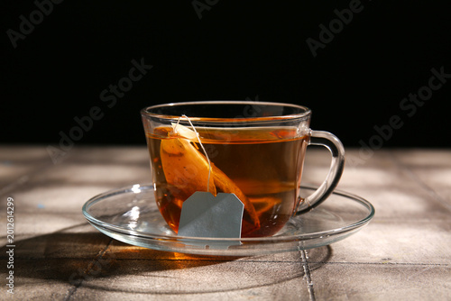 Glass cup of hot black tea ...