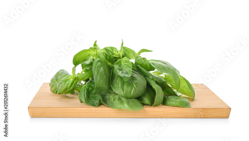 Wooden board with basil on ...