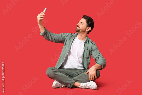 Young man with mobile phone...