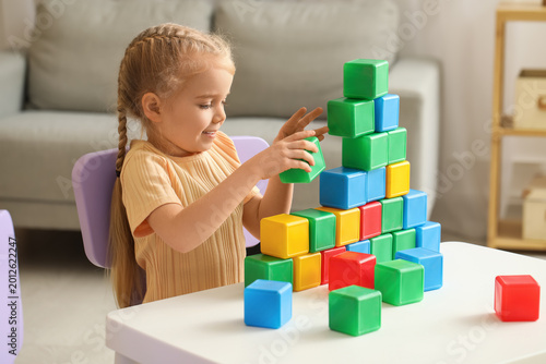 Cute little girl playing wi...