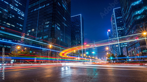 Cuadro en lienzo Energetic long exposure photograph of colorful car light trails sweeping through a vibrant city street at night