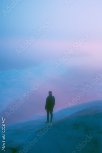 Vintage Film Photo of Man Standing on Snowy Coast with Grainy Texture, Faded Colors, 1980s Cinematic Look and Emotional Isolation