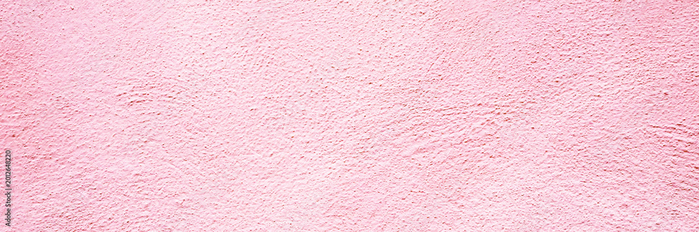 Fototapeta premium Wall of pink texture in a bright and open space with natural light shining during the day in the city setting