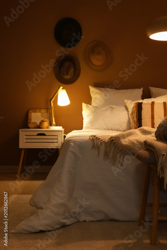 Tableau sur toile Interior of bedroom with glowing lamp on table at night