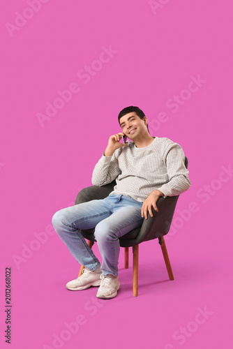 Young man talking by mobile...