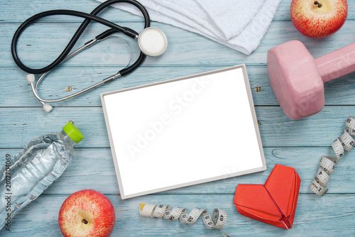 Billede på lærred Heart health and fitness concept with stethoscope and exercise equipment