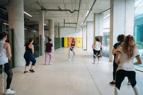 Women exercising during a group workout session in a gym