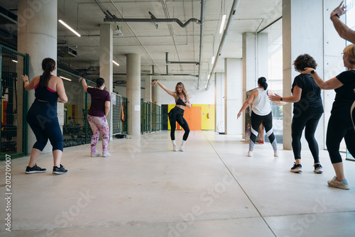 Fitness instructor teaching hip hop dance class to women