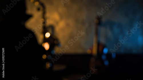 Musician silhouette playing instruments in a warm moody jazz club