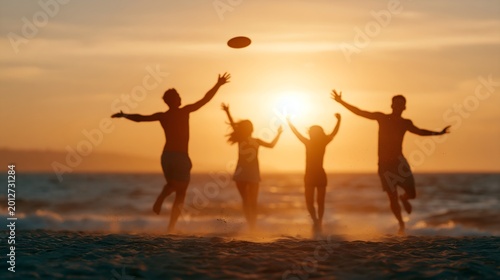 Silhouetted group jumping on beach
