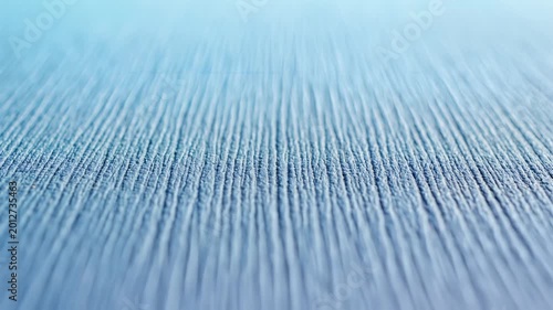 Abstract Blue Textured Surface with Vertical Lines and Soft Light.