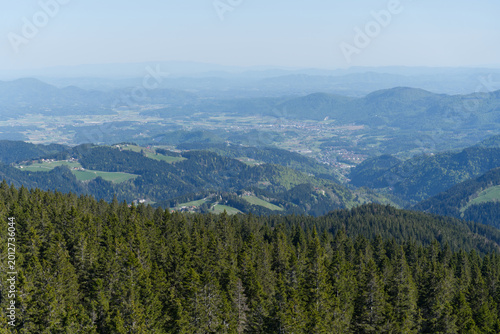 Wide panoramic view of mountain valley with remote villages and forests