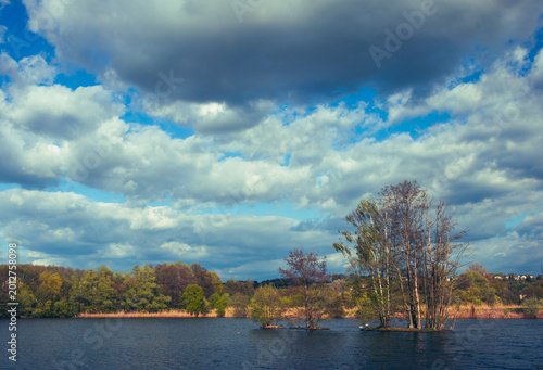 Spring Lake Landscape with Dramatic Clouds and Trees