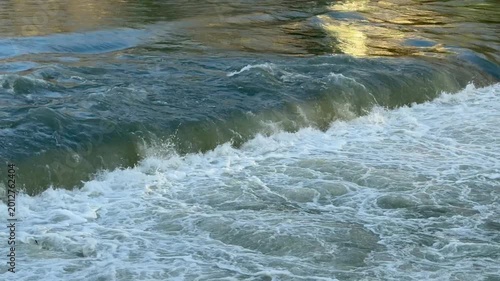 Close-up of water cascading over a low barrier