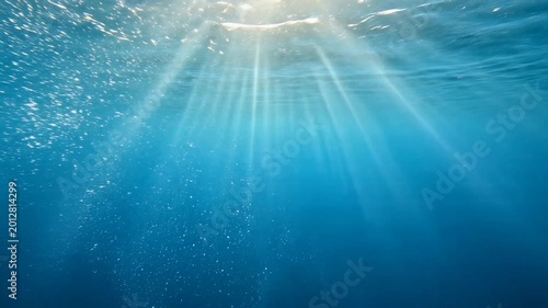 Sunlight Rays Shining Through Underwater Ocean Surface Bubbles.