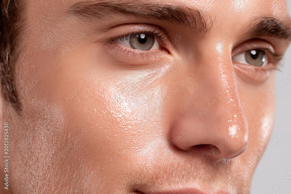 Fototapeta premium Hydrated male skin smooth texture close up natural skin glow healthy complexion radiant pores facial detail