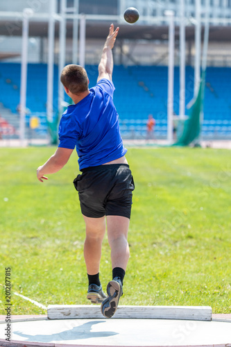 Young athlete shot put at athletics competitions