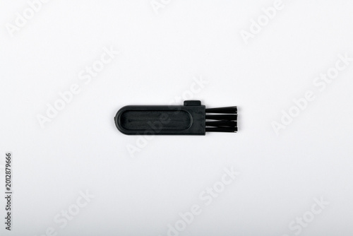 Close up top view of small black cleaning brush isolated on white background
