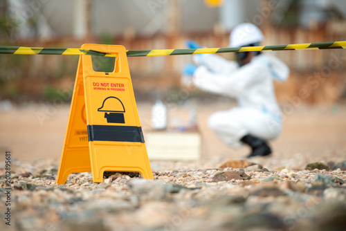 Photos Hazmat technician collecting environmental samples inside restricted hazardous