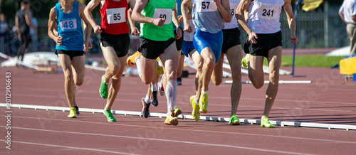 Group athletes running middle distance in athletics competitions