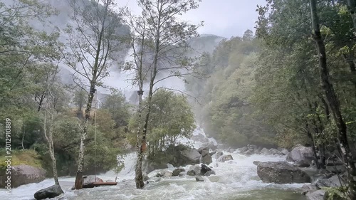 Dramatic view of the thundering Foroglio Waterfall, Cascata di Foroglio, crashing down a cliff in Val Bavona, Ticino, Switzerland, ideal for nature travel guides.
